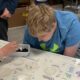 A special education student engages in a leaf pack study